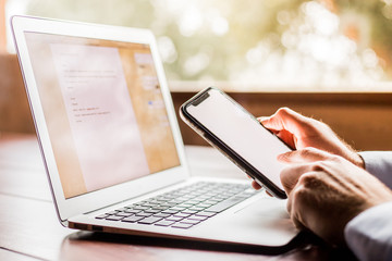 Workplace with a cup of tea and a laptop with some papers with pencil