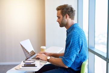 Startup entrepreneur using laptop in new office space