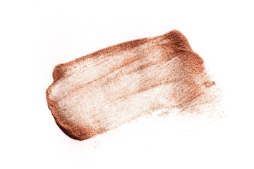 Smear of crushed golden eyeshadow as sample of cosmetics product isolated on white - Image
