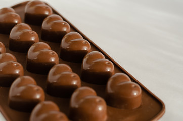 Silicone mold for treats. Brown chocolate mold in the shape of hearts. Eye level shooting....