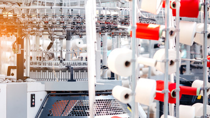 Textile Manufacturing. Circular knitted fabric. Textile factory in spinning production line and a...