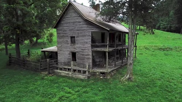 4K drone pushing in on an old abandoned derelict two story house