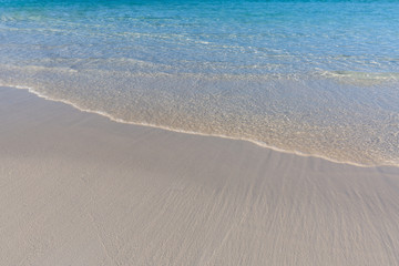 Fototapeta na wymiar Peaceful beach nature. Soft blue ocean wave on clean sandy beach. Soft beautiful ocean wave on sandy beach