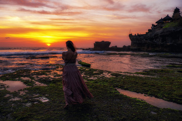 Woman against Pura Tanah Lot temple , Bali