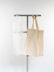 plastic bag vs eco natural reusable bag for shopping, flat lay on white background. Sustainable lifestyle concept. Zero waste. Reduse plastic free items.