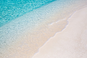Peaceful beach nature. Soft blue ocean wave on clean sandy beach.  Soft beautiful ocean wave on sandy beach