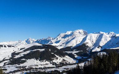 Mont Blanc (in background) and Saint-Gervais ski resort (in foreground) during winter season - View from Megeve, Haute-Savoie, Rhone-Alpes, France