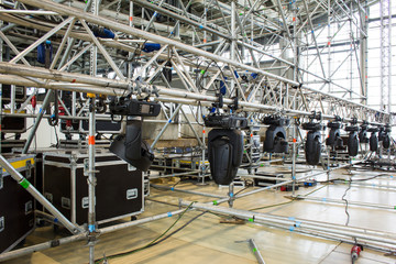 Moving head spotlight devices are clamped on a truss for lifting. Installation of professional...