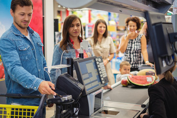 Couple buying goods in a grocery store