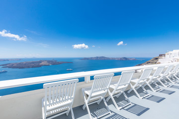  Santorini island. Romantic white chairs on white caldera with sea view. Luxury travel and vacation destination. Amazing summer landscape, sea view. Perfect tourism poster template, copyspace 