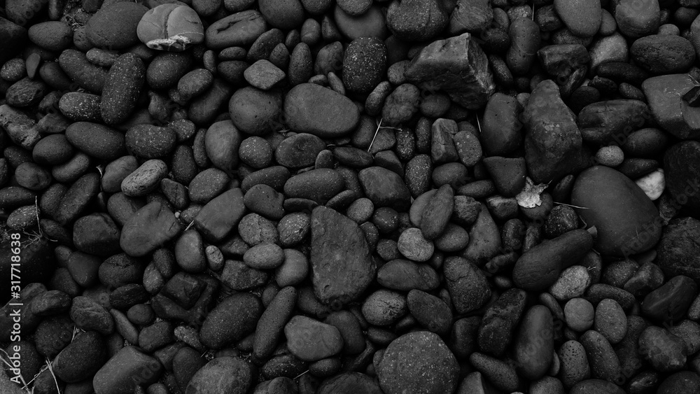 Wall mural black stones background. pebble beach