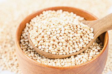quinoa seeds in wooden spoon.