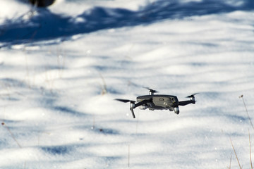 drone quadcopter with digital camera. Winter background.