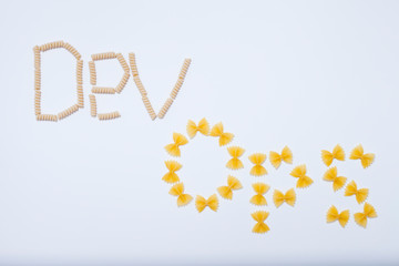 Devops concept. Developers and operations words made from pasta on the white background. Space for your text.