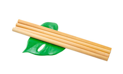 Bamboo straws tube for drink water with green leaf.