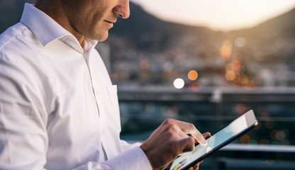 Mature businessman using a digital tablet on an office balcony