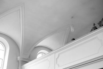 Monochrome inside of a Church with Woman watching