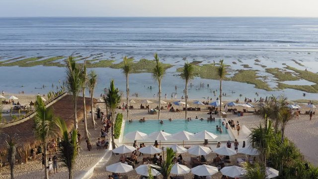 Aerial drone flight over beach club at Melasti beach, Bali, Indonesia, 4k, december 2019