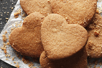 Delicious homemade cookie hearts on a dark background. Top view. Place for text.
