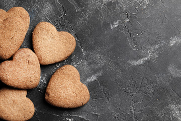 Delicious homemade cookie hearts on a dark background. Top view. Place for text.