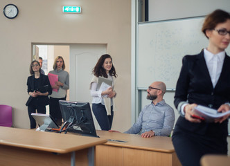 Lecturer and multinational group of students in an auditorium