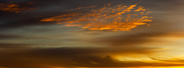 Panorama sunset cloudscape with dramatic cloud structures.