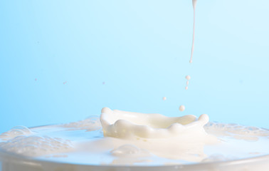 splash on the surface of white milk on a blue background