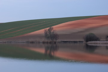 Reflection on an Hungarian lake with clear sky.