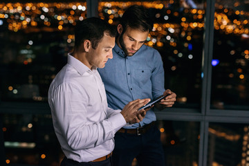 Business colleagues working online late at night in the office