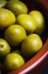 Still life of a plate of olive olives on a clay plate