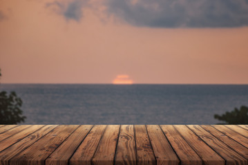 Wooden table for advertising products on the background of the sea sunset,