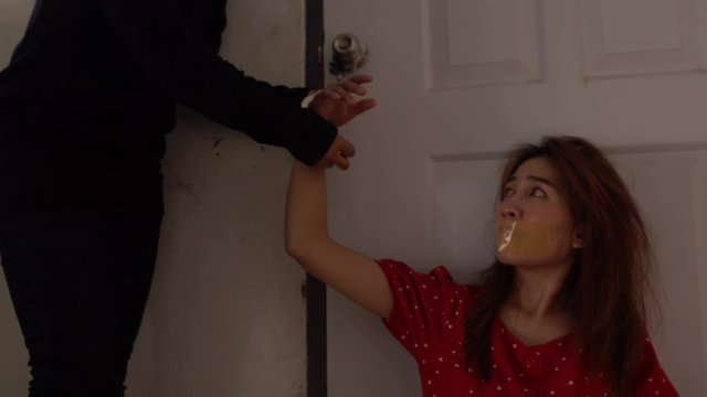 Asian hostage woman Bound with rope at night scene,The thieves kidnapped for ransom,thailand people