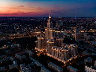 Plakat Night Moscow, high-rise building on a sunset background. Night view of the city and Triumph Palace. Aerial photo of the night city