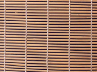 Empty Asian Food Background. brown Bamboo mat on black wooden background top view with copy space flat lay.