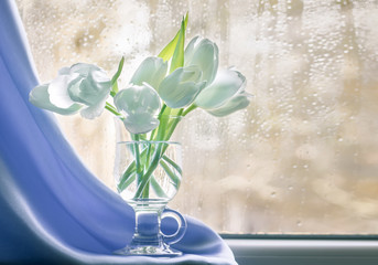 Still life with a bouquet of tulips on a windowsill