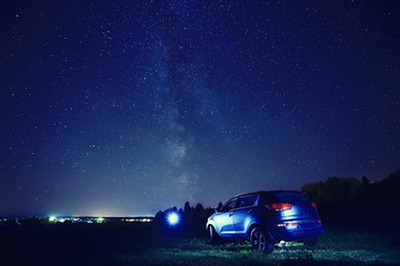 Fototapeta na wymiar night scenery of a star and a machine, an adventure in the night scenery, the milky way above travelers