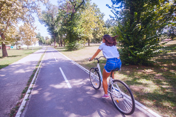 Pretty Woman Having Fun Riding Bicycle In Nature