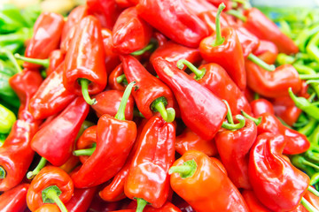 Display of locally grown red bell peppers for sale at local farmers market