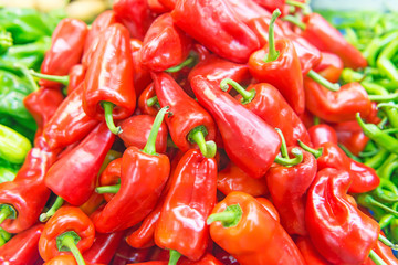 Display of locally grown red bell peppers for sale at local farmers market