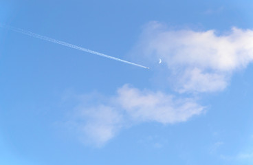 Clouds and blue sky on summer with airplane and moon.
