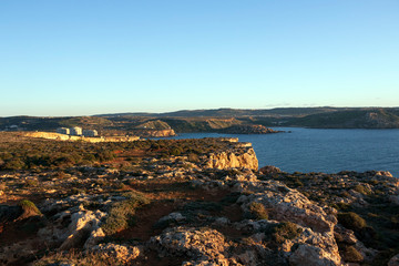 Sunset golden light on the coastline cliffs of the Golden Bay, Mediterranean sea island of Malta