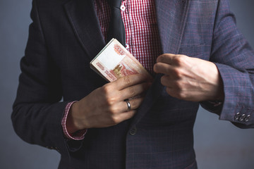 Married businessman in suit hides money