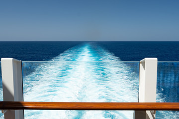 view over the waves to the horizon from the deck of a cruise ship, window, wood railing
