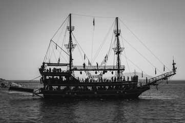 The silhouette of a large sightseeing boat. Rest and travel across the Aegean Sea of Turkey. Black and white.