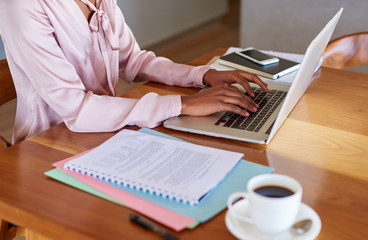 Young businesswoman getting work done on a laptop at home
