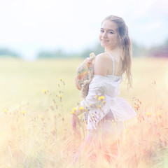 happy girl in autumn field with spikelets landscape / adult young girl portrait, summer look, nature