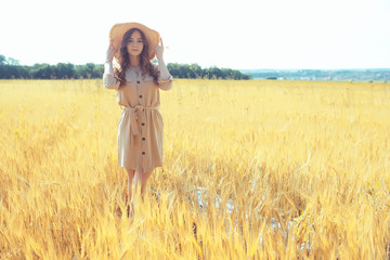 wheat field summer landscape, happy young model / freedom and relaxation concept in summer and autumn