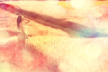 wheat field summer landscape, happy young model / freedom and relaxation concept in summer and autumn