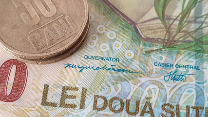 Close up of 50 Bani coins on top of 200 Lei Bank Note