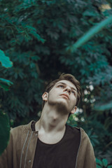 Unity with yourself. Glamorous charming guy looking at the camera and tilting his head posing on...